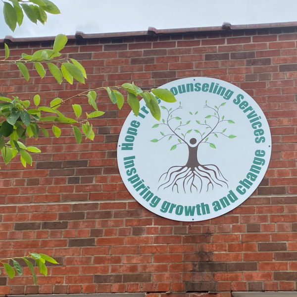 Sign and logo on Hastings Hope Tree brick facade